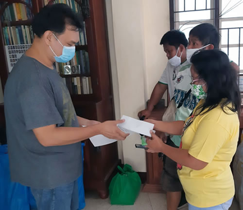 Fr. Andrei Pax accepts a donation to help purchase more groceries so the hungry can be fed.