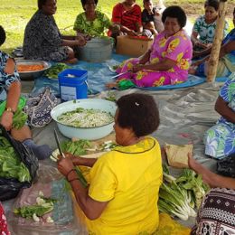 Ladies busily chopping and cooking